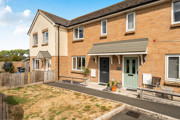 Front elevation of modern two-bedroom terraced house with private garden and parking