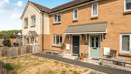Front elevation of modern two-bedroom terraced house with private garden and parking