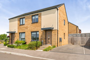 Semi-detached house with driveway, small front garden, and side access gate.