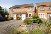 A semi-detached house house with a landscaped front garden and driveway.