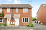 Two-storey brick semi-detached house with driveway and white front door.