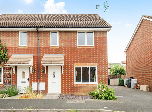 Two-storey brick semi-detached house with driveway and white front door.