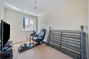 Home office or spare room with desk, chair and folded bed frame
