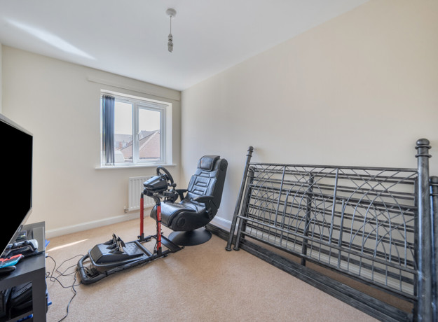 Home office or spare room with desk, chair and folded bed frame