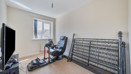Home office or spare room with desk, chair and folded bed frame