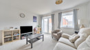 Living room with sofas, coffee table, television and patio doors.