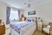 Bedroom with a double bed, bedside tables and window.