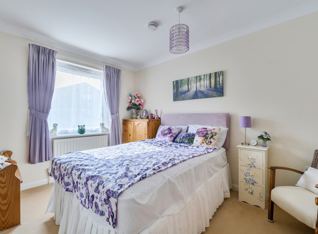 Bedroom with a double bed, bedside tables and window.
