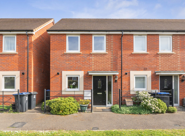 Two-storey red brick semi-detached house with white-framed windows