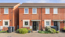 Two-storey red brick semi-detached house with white-framed windows