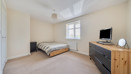 Spacious double bedroom with bed, chest of drawers and neutral decor