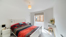 Double bedroom with bedside tables, vanity unit and window.