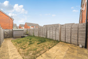 Rear garden with lawn, patio area, shed and fenced boundaries.