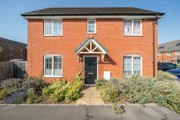 Detached brick house with a front garden and path leading to the entrance.