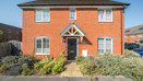 Detached brick house with a front garden and path leading to the entrance.
