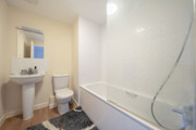 Bathroom with bathtub, shower screen, toilet and pedestal sink