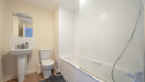 Bathroom with bathtub, shower screen, toilet and pedestal sink