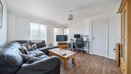 Living and dining area with wood flooring and access to the hallway.