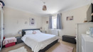 Bedroom with a double bed, wardrobe, window and chest of drawers.
