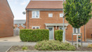 Brick semi-detached house with front lawn, hedge, and driveway.