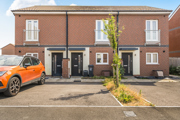 Two-storey red brick house with driveway parking and a small front garden.