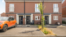 Two-storey red brick house with driveway parking and a small front garden.