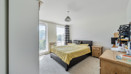 Bedroom with double bed, fitted furniture and a window.