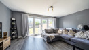 Bright living room with large sofa, french doors and natural lightf