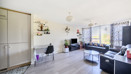 Bright open living area with wooden-effect flooring, wall décor and seating space