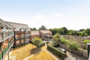 View across communal courtyard and landscaped gardens from balcony.
