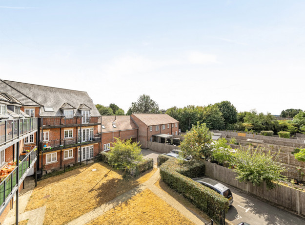 View across communal courtyard and landscaped gardens from balcony.