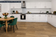 Modern fitted kitchen at Brickmark Place with integrated appliances and adjacent dining area.