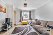 Bright living room with large window and neutral décor