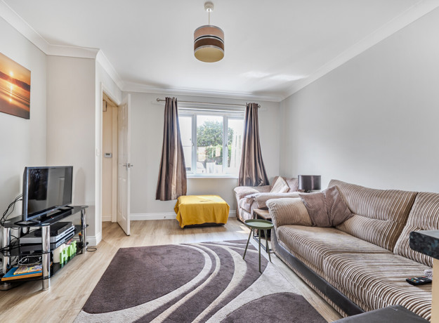 Bright living room with large window and neutral décor