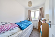 Bedroom with a single bed, desk and window.
