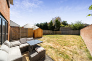 Patio seating area with outdoor furniture and enclosed garden space