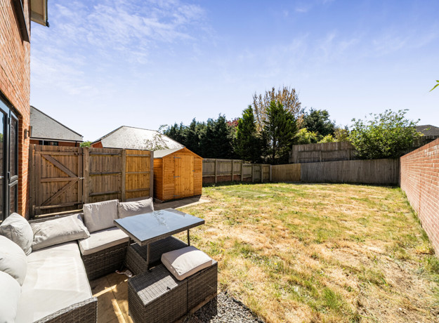 Patio seating area with outdoor furniture and enclosed garden space
