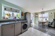 Open-plan kitchen and dining area with fitted units and garden access.