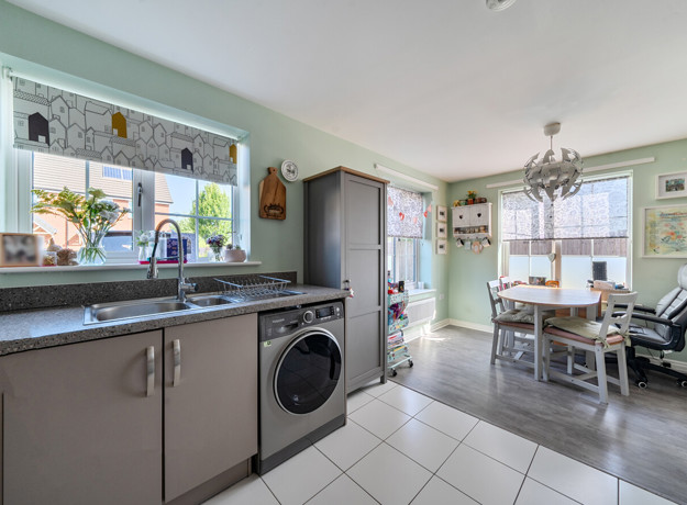 Open-plan kitchen and dining area with fitted units and garden access.
