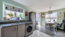 Open-plan kitchen and dining area with fitted units and garden access.