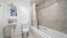 Bathroom with bathtub, shower, toilet, sink, and wall mirror.