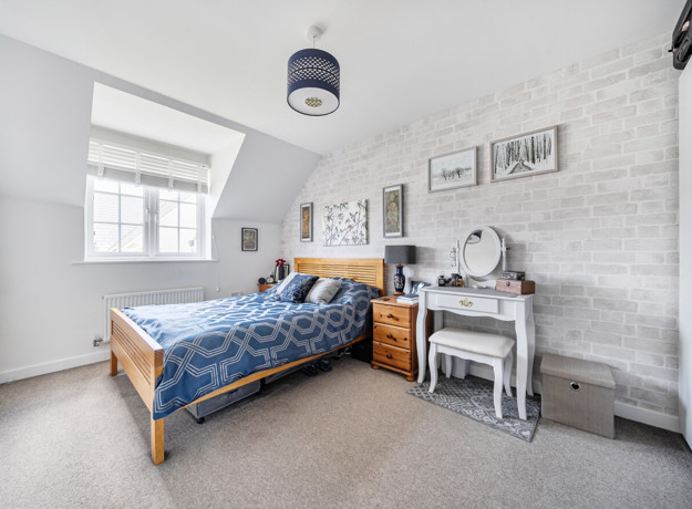 Bedroom with double bed, bedside table and window.