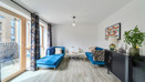 Living room with seating, curtains and balcony access.