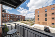 Balcony view overlooking apartment buildings and looking onto river.