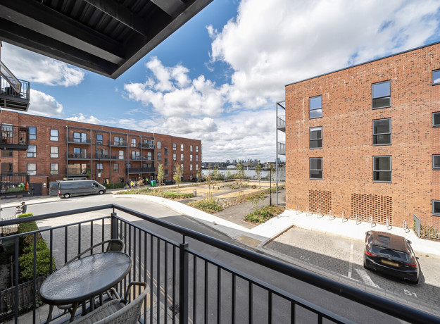Balcony view overlooking apartment buildings and looking onto river.