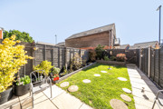 Landscaped garden with paving, grass areas, stepping stones and fenced boundaries