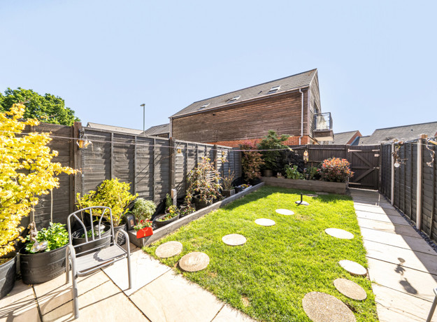 Landscaped garden with paving, grass areas, stepping stones and fenced boundaries