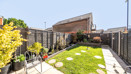 Landscaped garden with paving, grass areas, stepping stones and fenced boundaries
