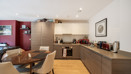 Open-plan kitchen with dining table, cabinets, and countertop appliances.