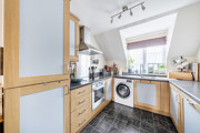 Kitchen with fitted units, appliances and washing machine.
